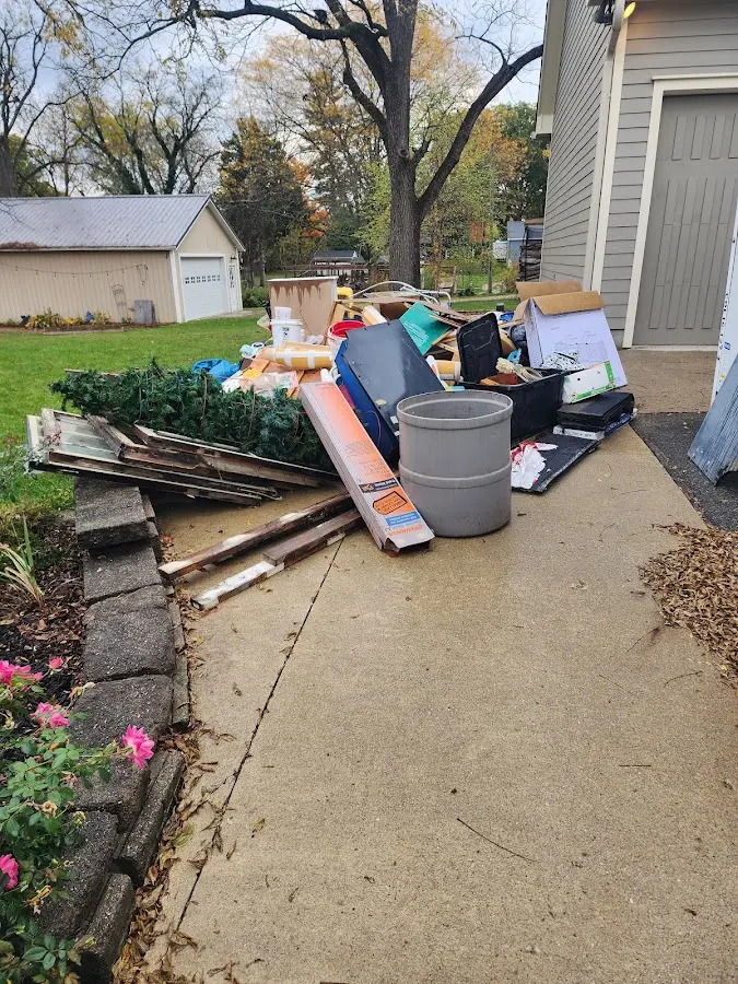 Dumpster being loaded with debris for 12 Yard Dumpster Rental in Eureka